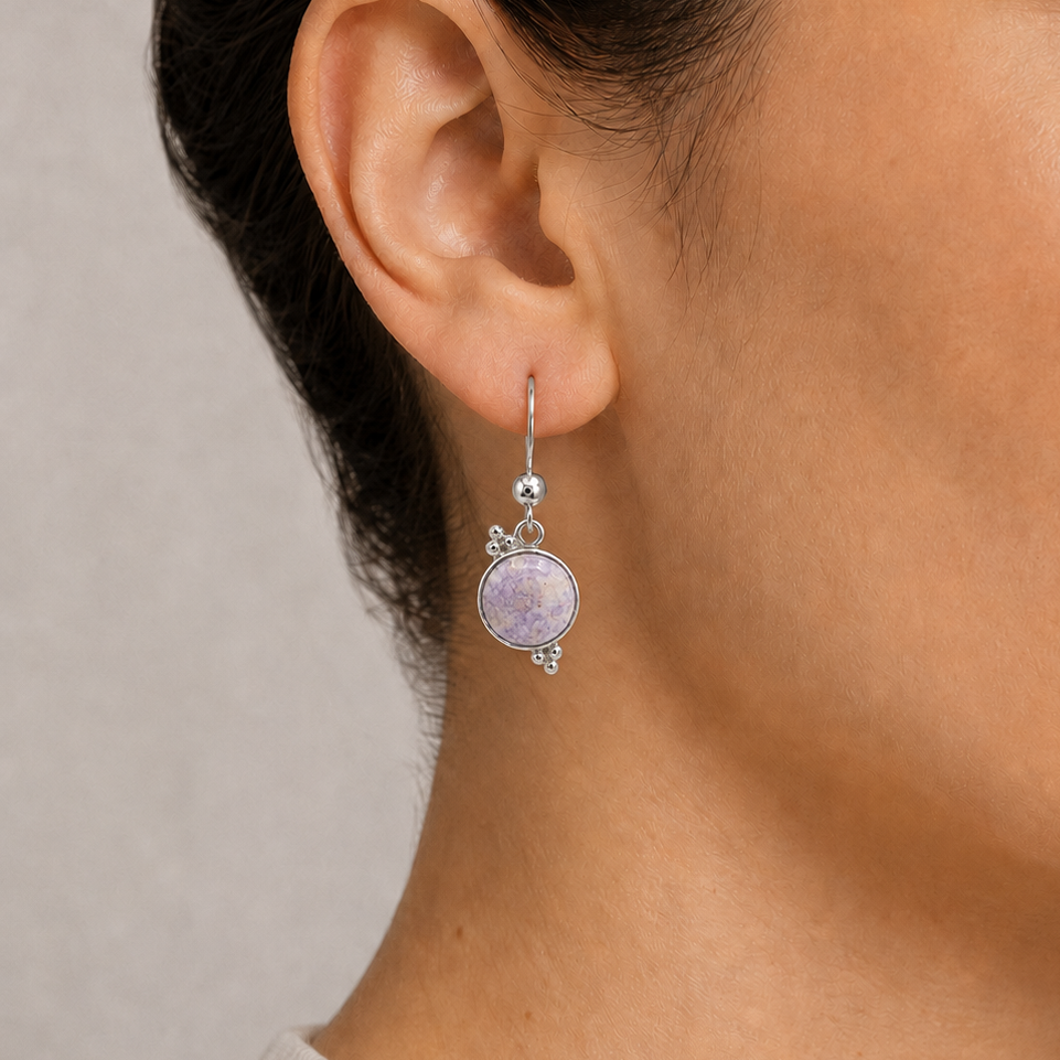 Close-up of a woman wearing a lilac jade earring with sterling silver 