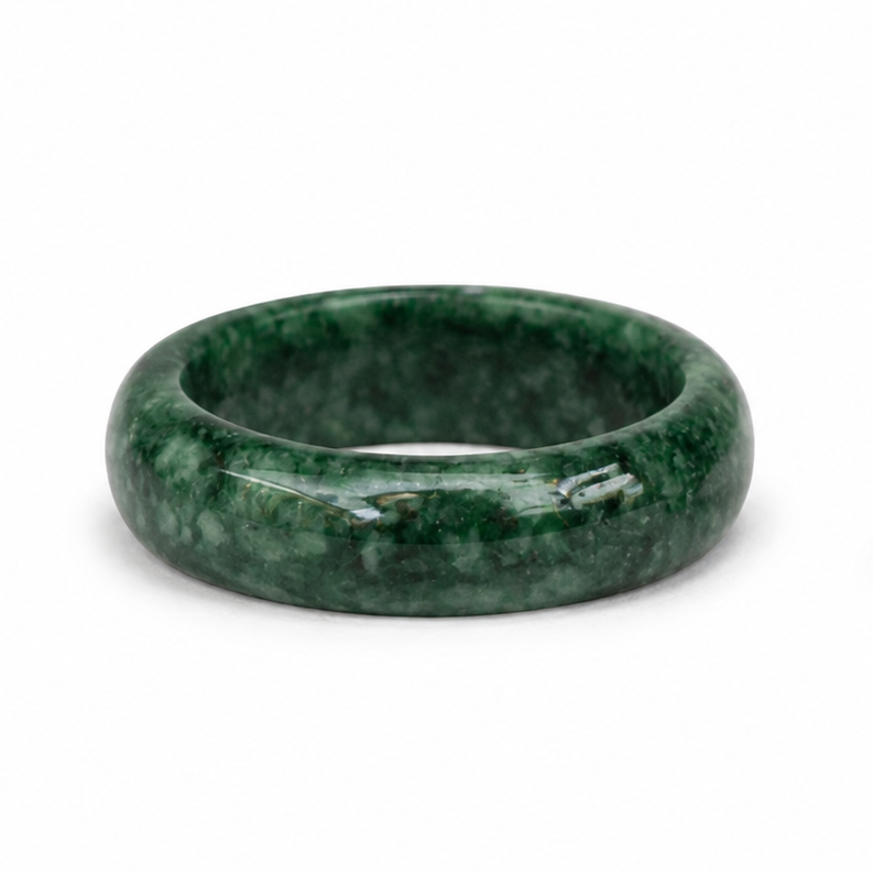 Green stone jade ring shown on a white background, viewed from the side, displaying a mottled dark green texture.