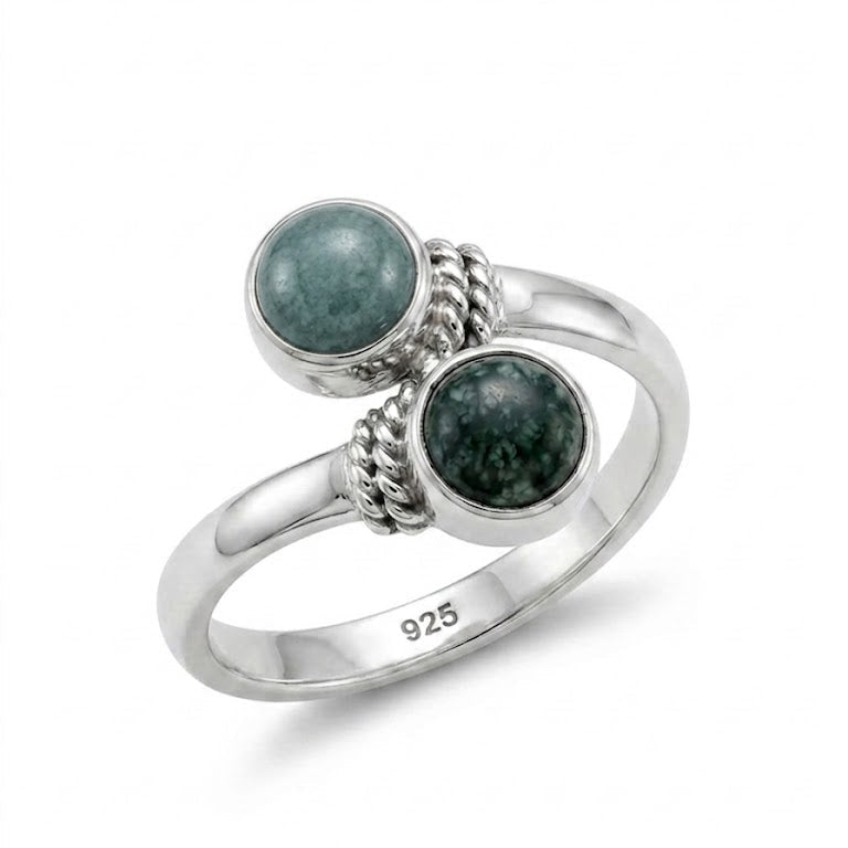 Silver ring with two jade stones on a white background