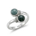 Silver ring with two jade stones on a white background
