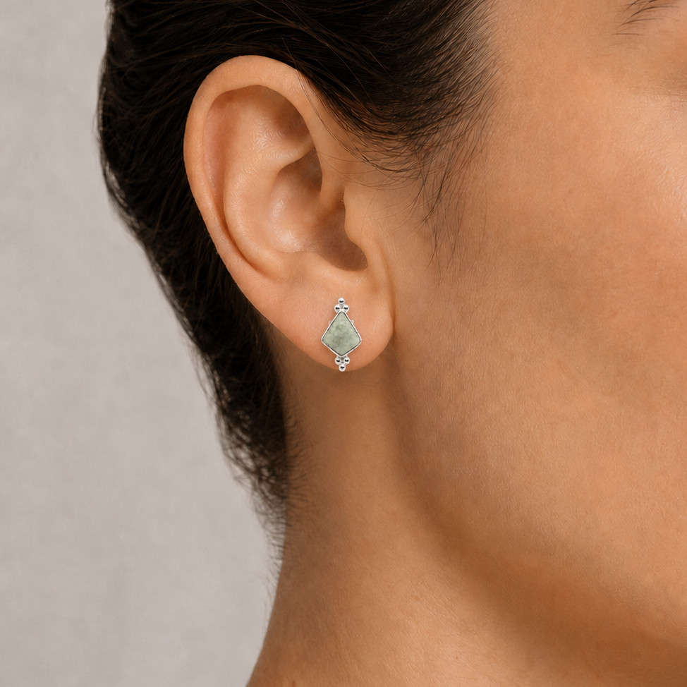 Close-up of a woman wearing jade earring