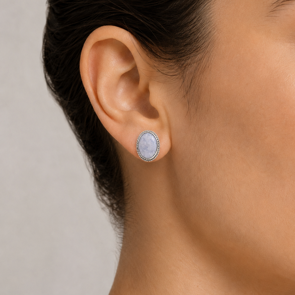 Close-up of a woman wearing a lilac jade stud earring 