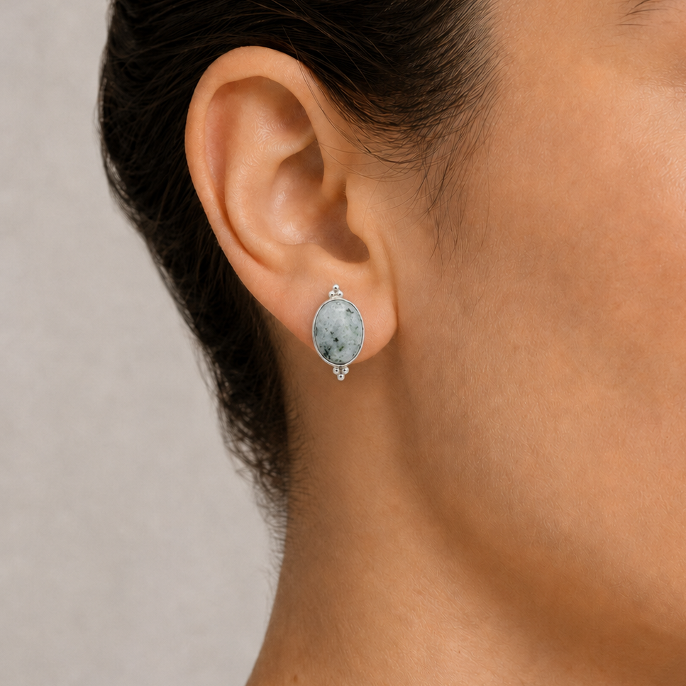 Close-up of a woman wearing a jade earring