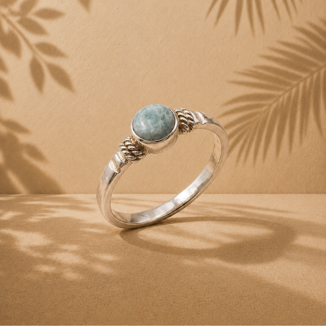 One stone jade ring against sandstone background 