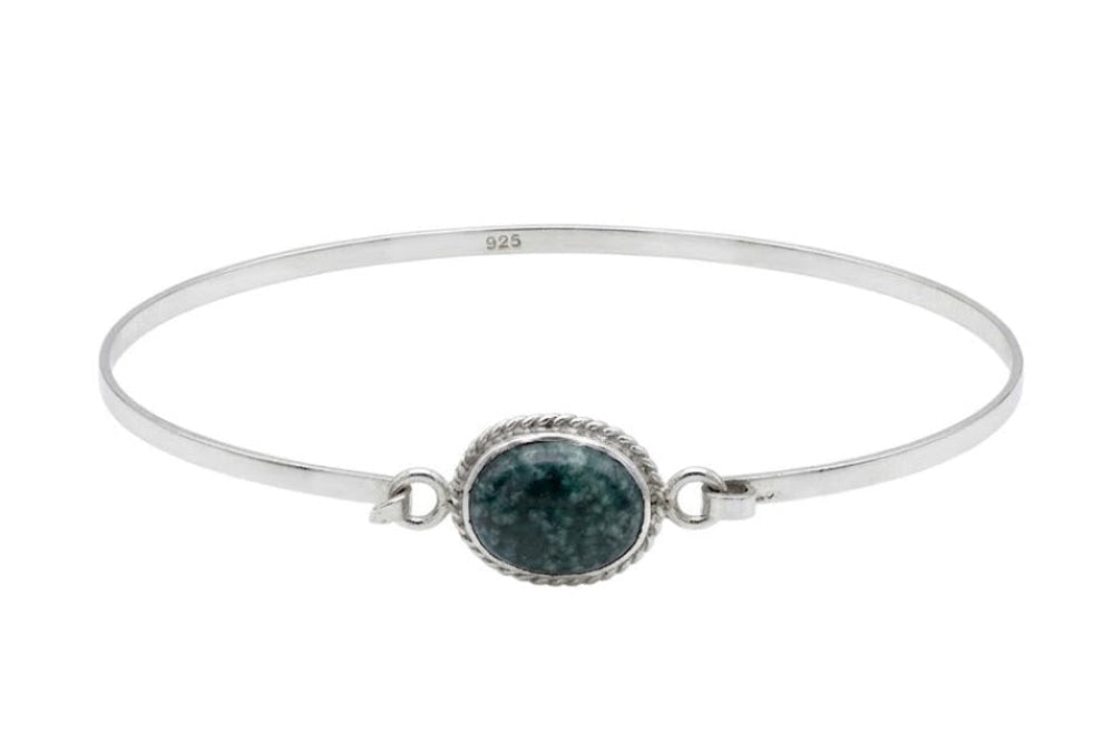 Silver bracelet with a green jade stone on a white background
