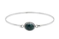 Silver bracelet with a green jade stone on a white background