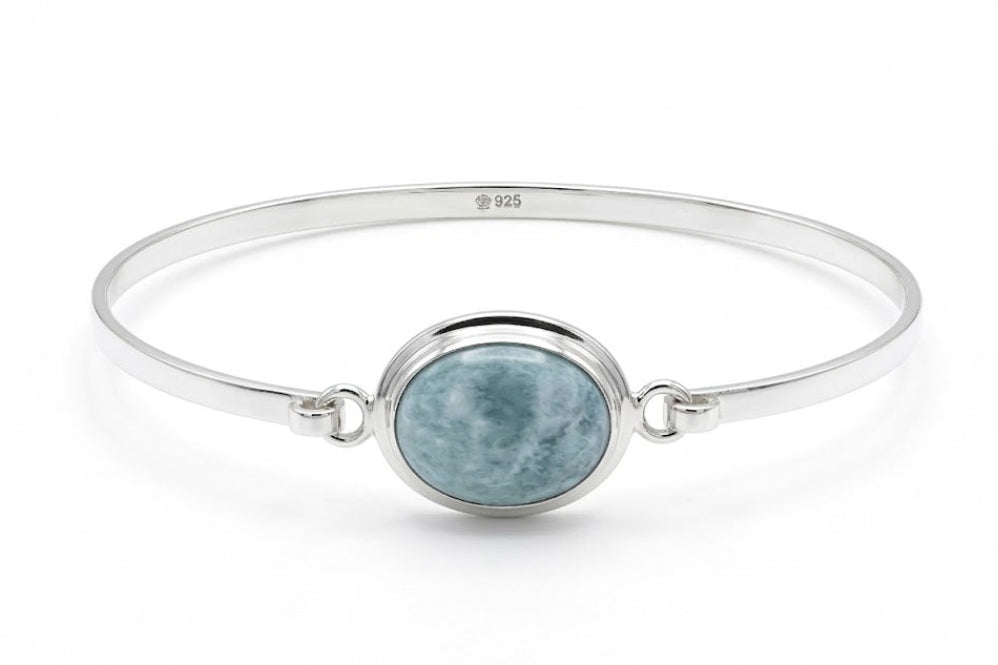 Silver bracelet with a round blue jade stone on a white background